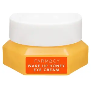 Gelber Cremetiegel mit weißem Deckel, orangefarben etikettiert, darauf "Wake Up Honey Eye Cream".