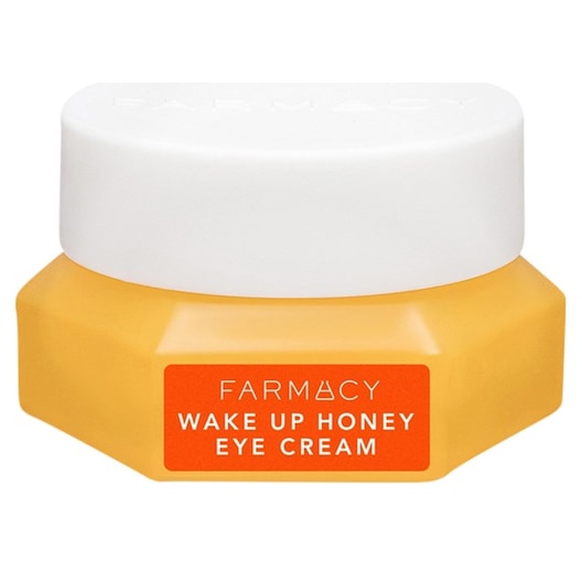 Gelber Cremetiegel mit weißem Deckel, orangefarben etikettiert, darauf „Wake Up Honey Eye Cream“. Gelber Cremetiegel mit weißem Deckel, orangefarben etikettiert, darauf