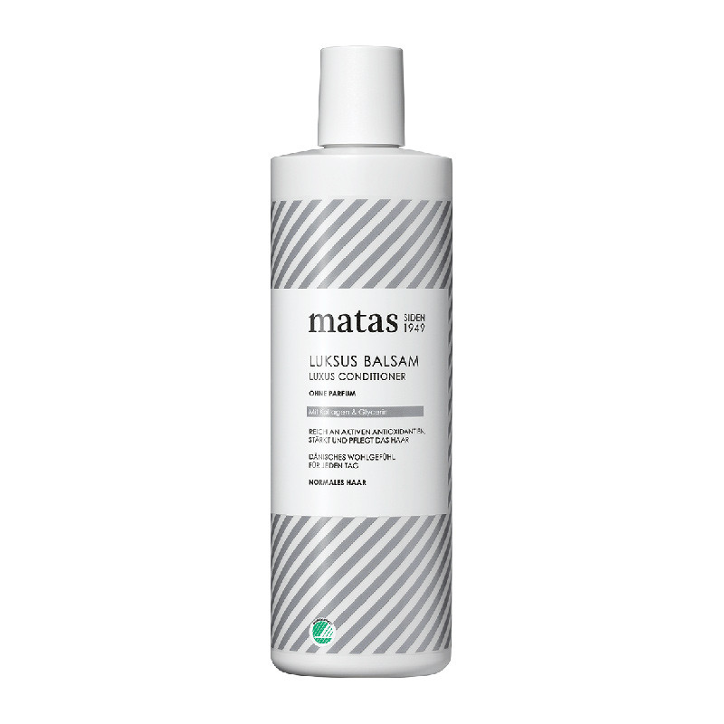 Weiße Flasche mit grauen Streifen und Matas Luxus Conditioner Aufschrift.