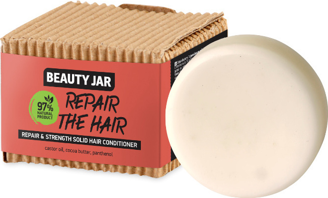 Fester Conditioner in Verpackung aus Pappe mit aufgedrucktem Text und Inhaltsstoffen. Fester Conditioner in Verpackung aus Pappe mit aufgedrucktem Text und Inhaltsstoffen.