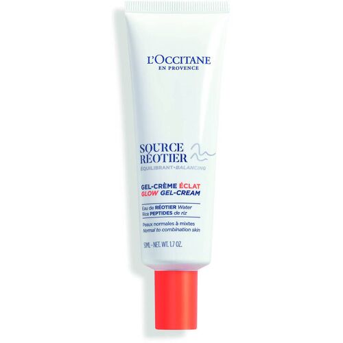 Weiße Tube einer Gesichtspflegecreme mit roter Kappe und blauer Aufschrift.