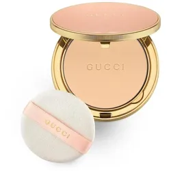 Goldener Kompaktpuder von Gucci mit Applikator vor weißem Hintergrund.