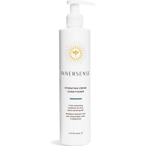 Weiße Conditioner-Flasche mit Pumpverschluss und goldenem Logo von Innersense.