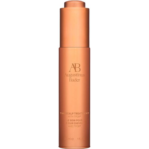 Bronze farbene Produktflasche mit Aufschrift „Augustinus Bader“ und „The Scalp Treatment“ Bronze farbene Produktflasche mit Aufschrift