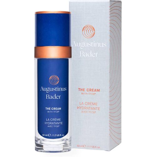 Blaue Cremeflasche mit orangem Deckel neben weißer Verpackungsbox.