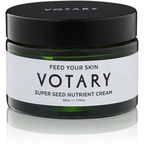 Grüner Glasbehälter mit schwarzem Deckel, beschriftet mit Votary Super Seed Nutrient Cream. Grüner Glasbehälter mit schwarzem Deckel, beschriftet mit Votary Super Seed Nutrient Cream.
