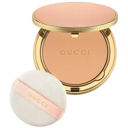 Kompaktpuder in goldener Dose mit beige Puderquaste.