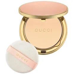 Kompaktpuder in goldener Hülle mit weißem Applikator und Gucci-Logo.
