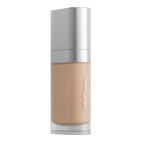 Transparente Foundation-Flasche mit silbernem Deckel, r.e.m.beauty-Logo sichtbar.