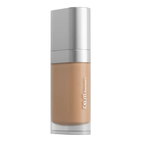 Eine braune Foundation-Flasche mit silbernem Verschluss und r.e.m Beschriftung. Eine braune Foundation-Flasche mit silbernem Verschluss und r.e.m Beschriftung.