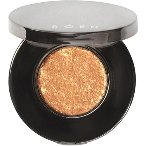 Runde Dose mit goldenem schimmerndem Lidschatten.