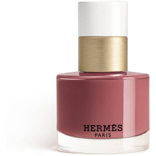 Elegante Hermès-Nagellackflasche mit goldener und weißer Kappe. Elegante Hermès-Nagellackflasche mit goldener und weißer Kappe.