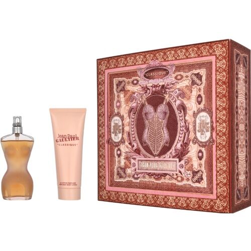 Parfümflasche und Körperlotion neben dekorativer Geschenkbox mit verzierten Mustern. Parfümflasche und Körperlotion neben dekorativer Geschenkbox mit verzierten Mustern.