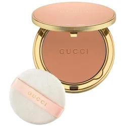 Kompaktpuder mit goldener Verpackung und weißer Applikationsschwamm.