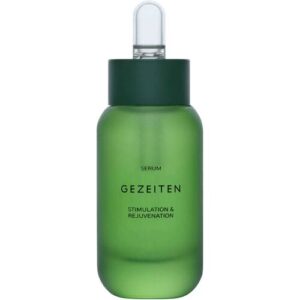 Grüne Flasche eines Serums mit schwarzem Verschluss und Tropfer.