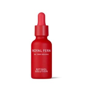 Rote Flasche mit Pipette, Aufschrift "Royal Fern Retinol Solution" auf weißem Hintergrund.
