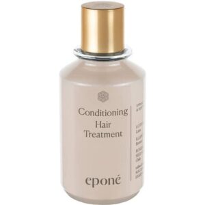 Beige Haarpflegeflasche mit goldenem Verschluss und schwarzer Schrift.