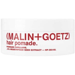 Weiße runde Dose mit rotem Schriftzug "Malin+Goetz Hair Pomade"
