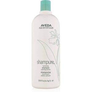 Weiße Shampoo-Flasche mit blauer Kappe und Pflanzenillustration.