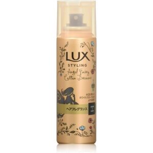Goldene Lux Haarsprayflasche mit floralem Design und stilisierter Figur.