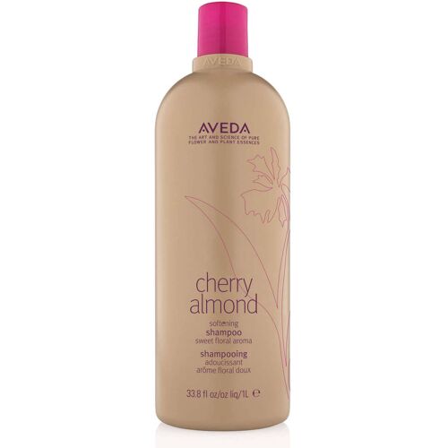 Beigefarbene Shampoo-Flasche mit rosa Deckel und Blumenmuster, Etikett mit „Cherry Almond“. Beigefarbene Shampoo-Flasche mit rosa Deckel und Blumenmuster, Etikett mit