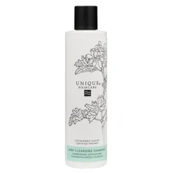Weiße Shampooflasche mit schwarzem Deckel und Pflanzenmotiv.